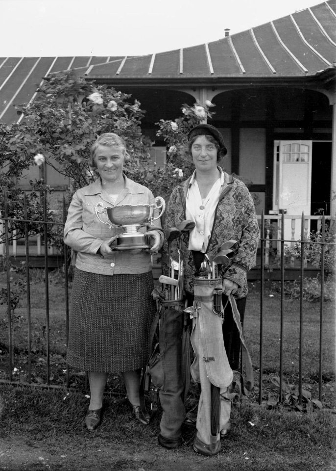 Two lady golfers outside Llandrindod Wells Golf Club pavilion, one holding the Open Challenge Bowl, 1933 (1295167)