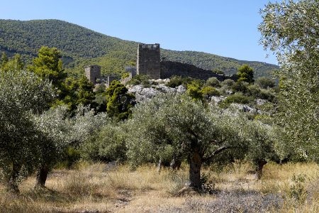 Two fortification towers and wall of the ancient Megarian Castle of Aigosthena on August 27, 2020