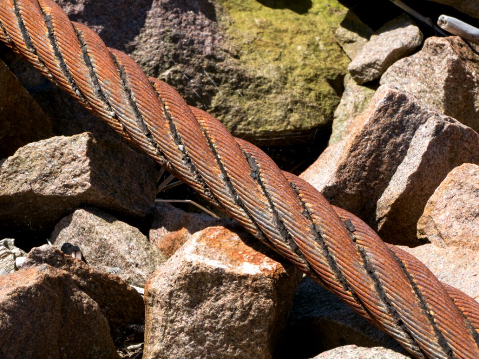 Old mooring steel wire rope and granite
