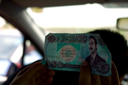 Old Saddam-era notes found on the body of an ISIS fighter by a Peshmerga soldier 01