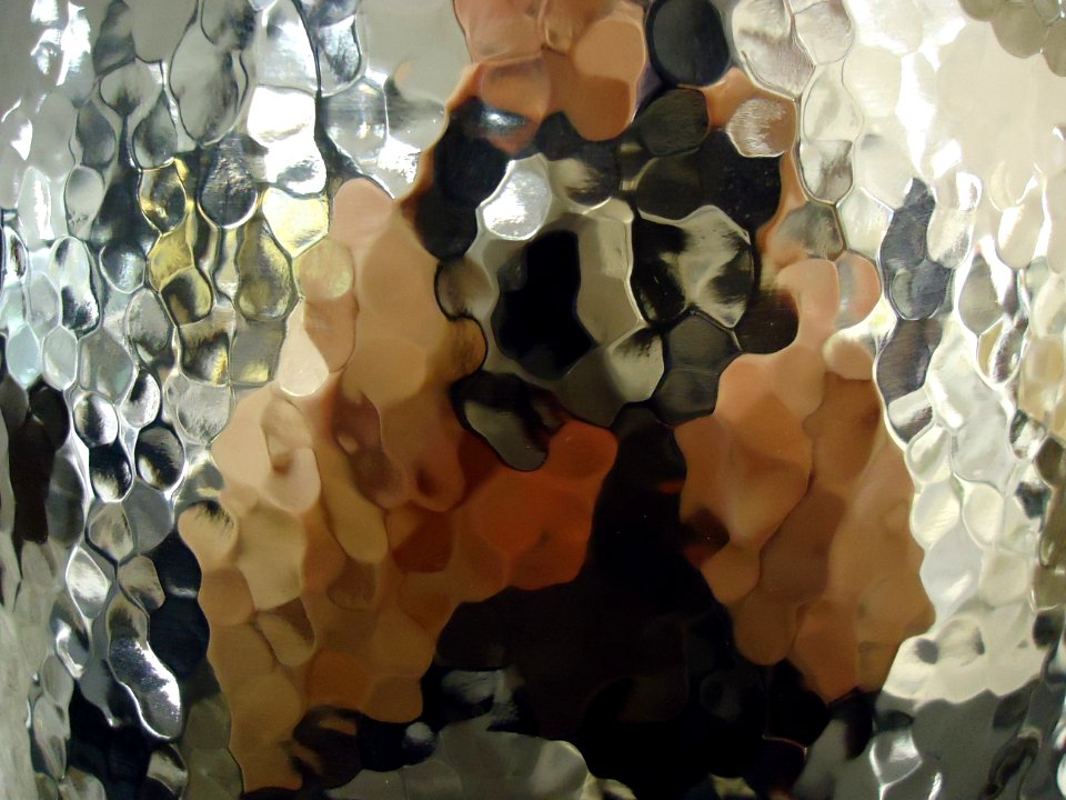 Photo of reflected image distorted by translucent glass in display in mall