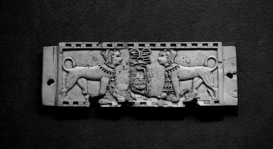Phoenician-style Nimrud ivory of two sphinxes flanking a cartouche