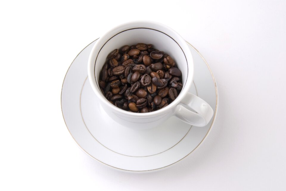 Saucer coffee beans a cup of coffee