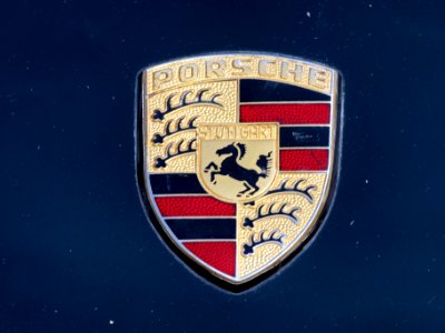 Porsche emblem on a blue Porsche