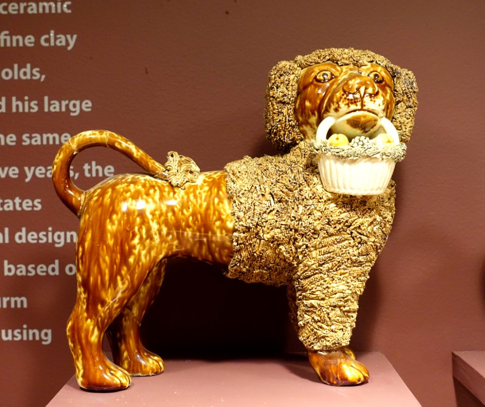 Poodle figure, United States Pottery Company, 1847-1858, Rockingham glaze with flint enamel glazed basket - Bennington Museum - Bennington, VT - DSC09010