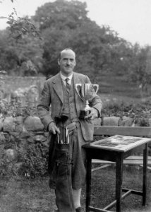 Portrait of a man holding the Builth Golf Cup (1293978)