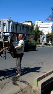 Portage horse - a man giving water to her horse with pail aside of Amir Kabir St - Nishapur 1