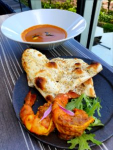 Prawn tandoori, sesame nan, goa coconut curry, at Tokvo Midtown