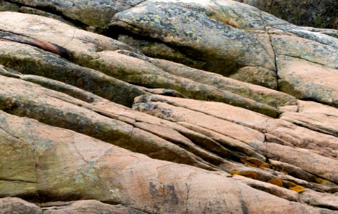 Red granite cliffs with lichen in Govik