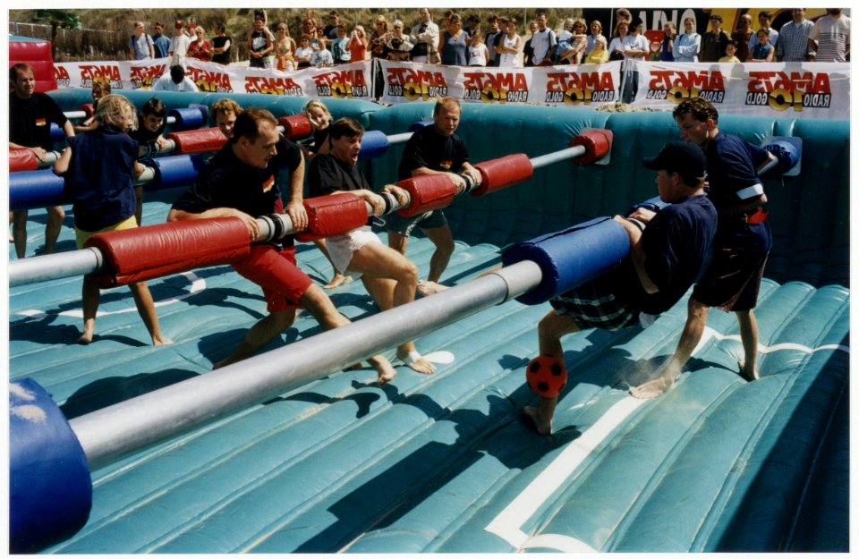 Recreatie op het strand levend tafelvoetbal. NL-HlmNHA 54036348