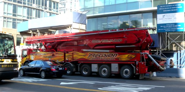 Red concrete pump truck 11th Av jeh