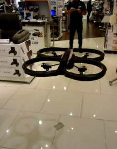 Remote controlled hovering vehicle flying in store in a mall photo