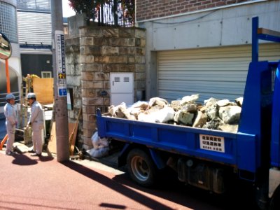 Removing stones from an ancient cliff wall in Motoazabu