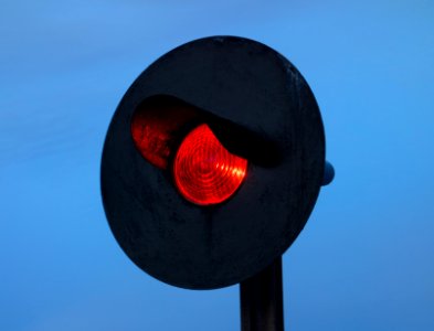 Red railway signal at dusk