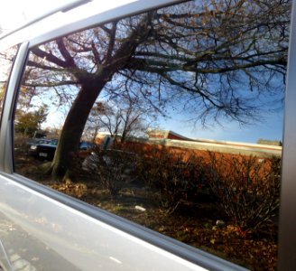 Reflection in car window glass Summit library in reflection