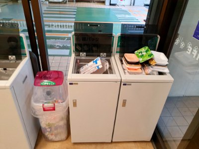 Recycling bins in a Japanese supermarket- caps, juiceboxes, styrofoam trays photo