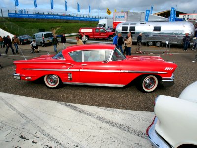 Red 1958 Chevrolet Impala side photo