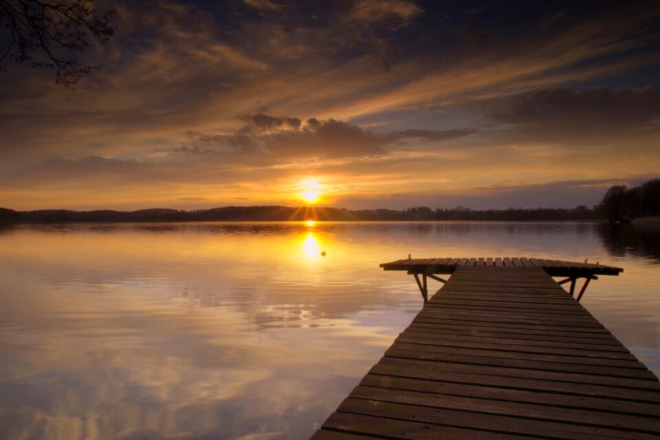 Sunset the water is calm clouds