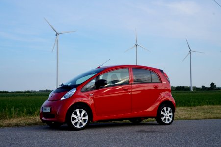 Public domain image - Peugeot iOn electric car in front of wind turbines photo