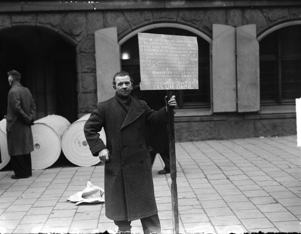Protest tegen belastingaanmaning door man met bord in Amsterdam, Bestanddeelnr 904-4165
