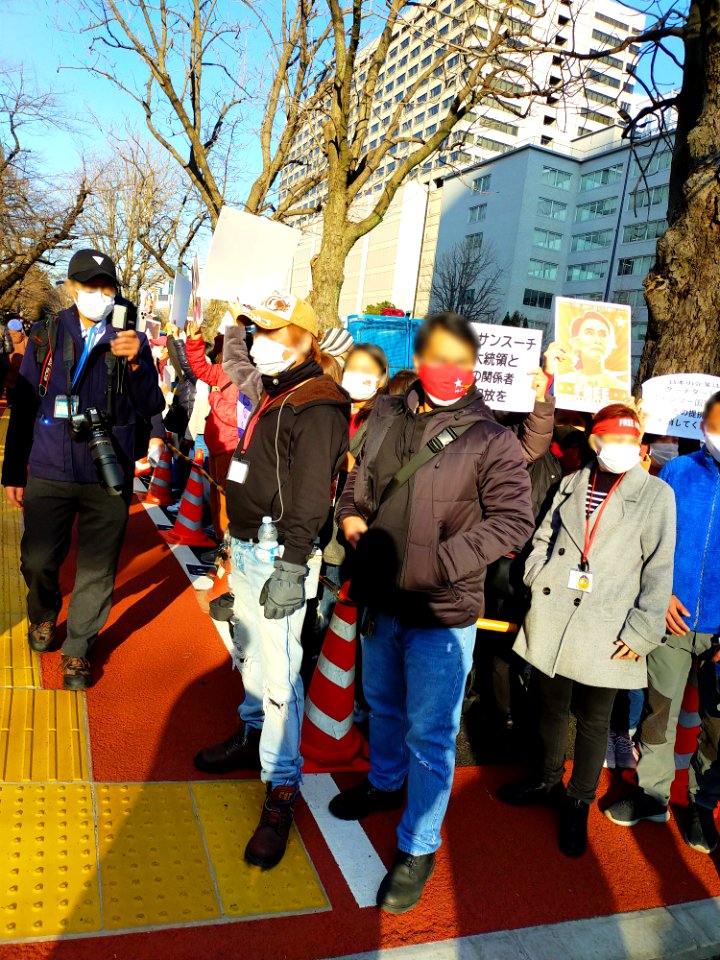 Protesters demanding Aung San Suu Kyi's release at Kasumigaseki, Tokyo after the February 2021 Myanmar coup, with posters asking the Japanese government to stop enabling the junta