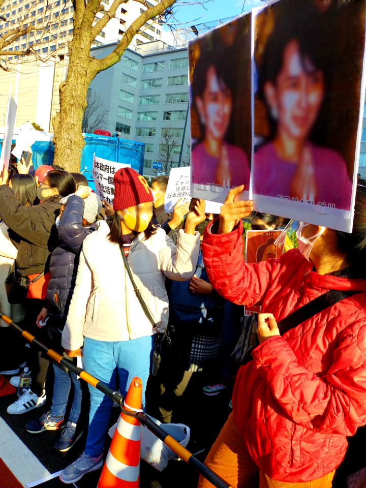 Protesters demanding Aung San Suu Kyi's release at Kasumigaseki, Tokyo after the February 2021 Myanmar coup, with posters asking Japanese companies to stop enabling the junta