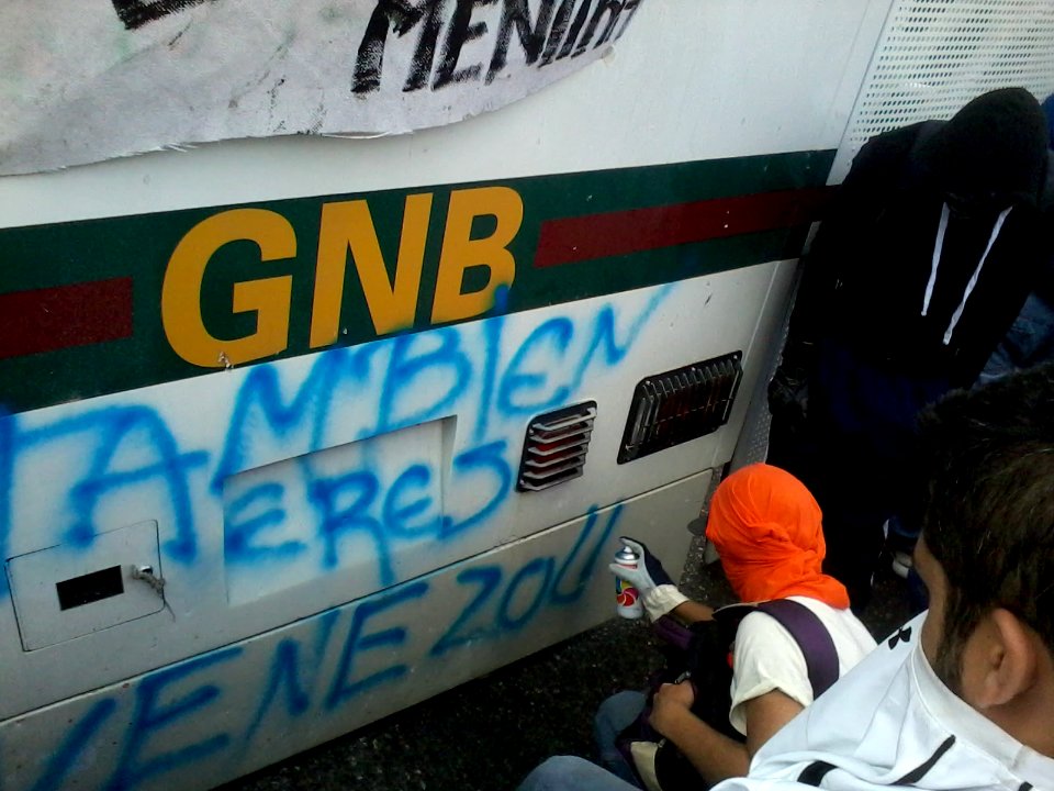 Protester spraying Venezuela 2014