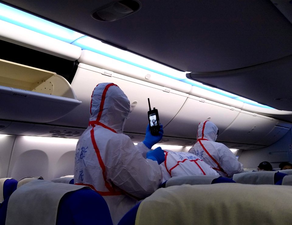 Quarantine staff screening passengers in Shenzhen