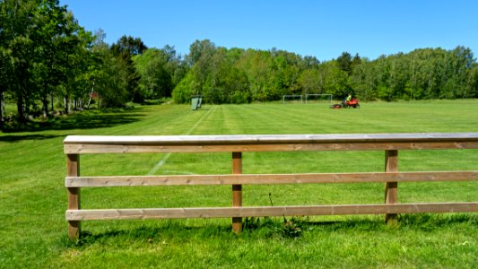 Riding mower in the north soccer field in Brastad 3 photo