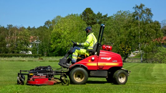 Riding mower in the north soccer field in Brastad 2 photo