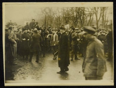 Samenscholing of demonstratie van burgers en militairen bord met het opschrift , Bestanddeelnr 158-1295
