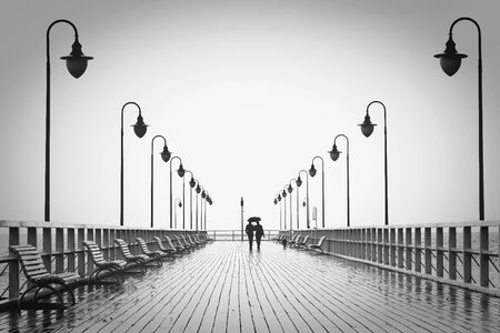 Man boardwalk sea photo