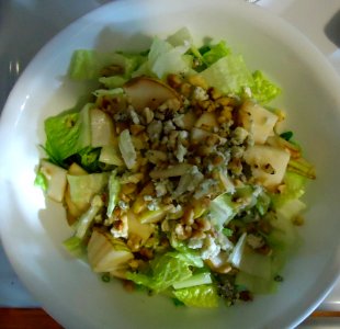 Salad with lettuce and nuts and sliced pears photo