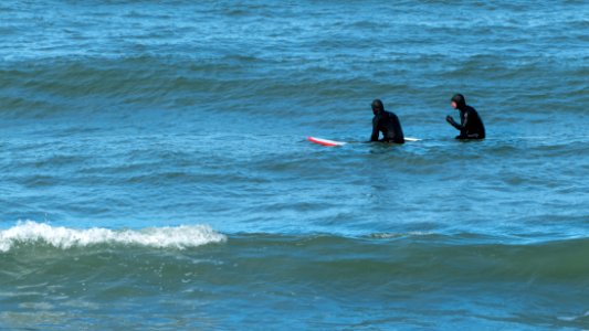 Two surfers waiting for a wave photo