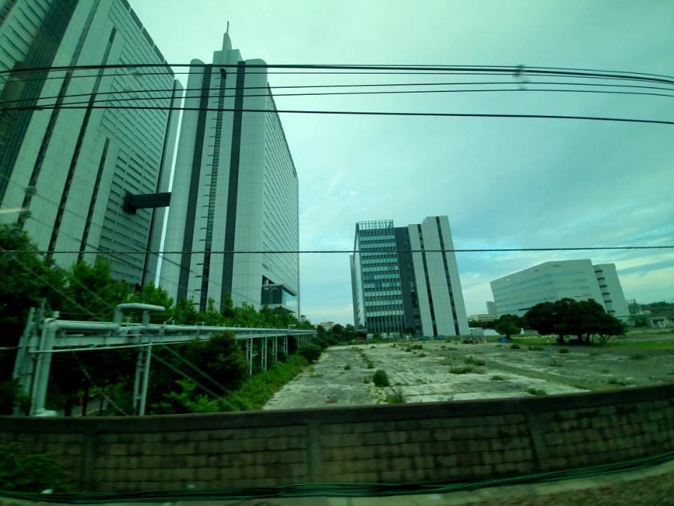 Vacant land surrounded by NEC buildings