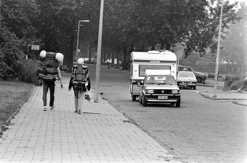 Vakantiegangers met rugzakken en een auto met caravan, Bestanddeelnr 932-6311