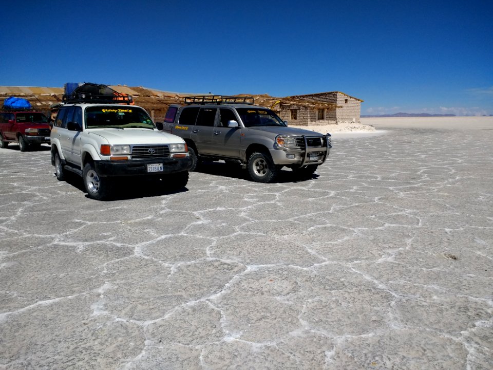 Vehicles in front of a salt hotel - Salar de Uyuni