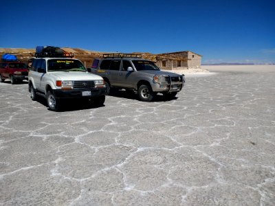 Vehicles in front of a salt hotel - Salar de Uyuni