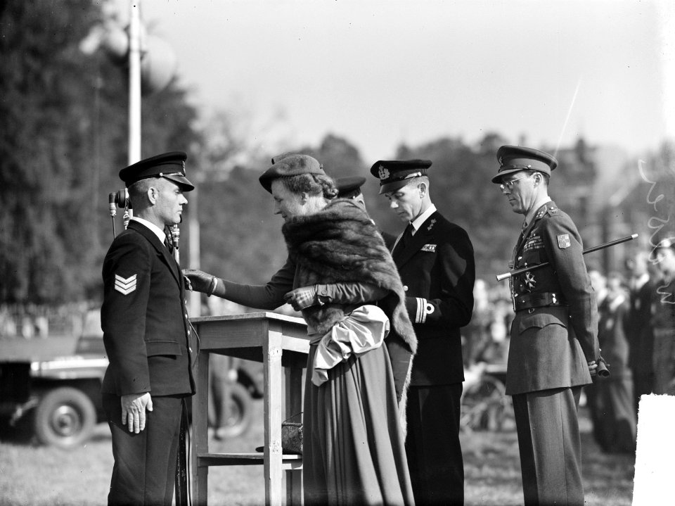 Uitreiking decoraties in Arnhem (Park Sonsbeek). Koningin Juliana spelt ondersch, Bestanddeelnr 903-0443