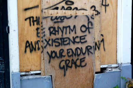Urban poetry of the famous street-poet in Amsterdam on mobile building-walls from photographer, Fons Heijnsbroek