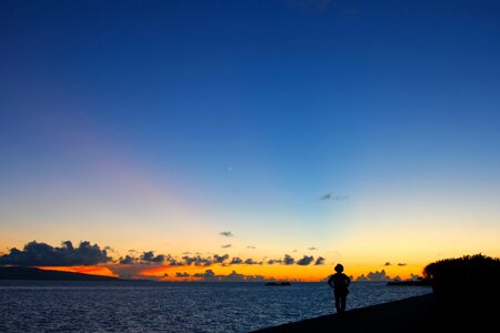 People silhouette sea