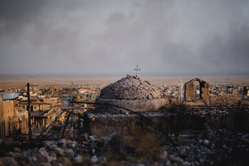 Views in June of 2019 of a cathedral rising above ruined buildings in the old neighborhood of Shingal (Sinjar) 18