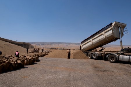 Views of the governmental grain depot in summer of 2019 in Shingal where Ezidi laborers are packing grain 10