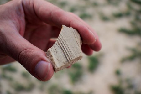 Views of pottery sherds, previous excavation sites, and the mound itself at 'Kelik Mishik' archaeological mound in Erbil 05