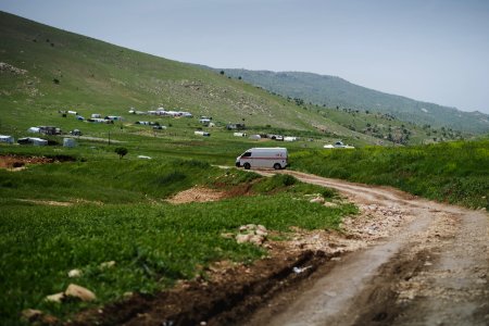 View of an ambulance struggling to drive through Sardashte Camp for Ezidi IDPs in May of 2019, atop Shingal mountain 01