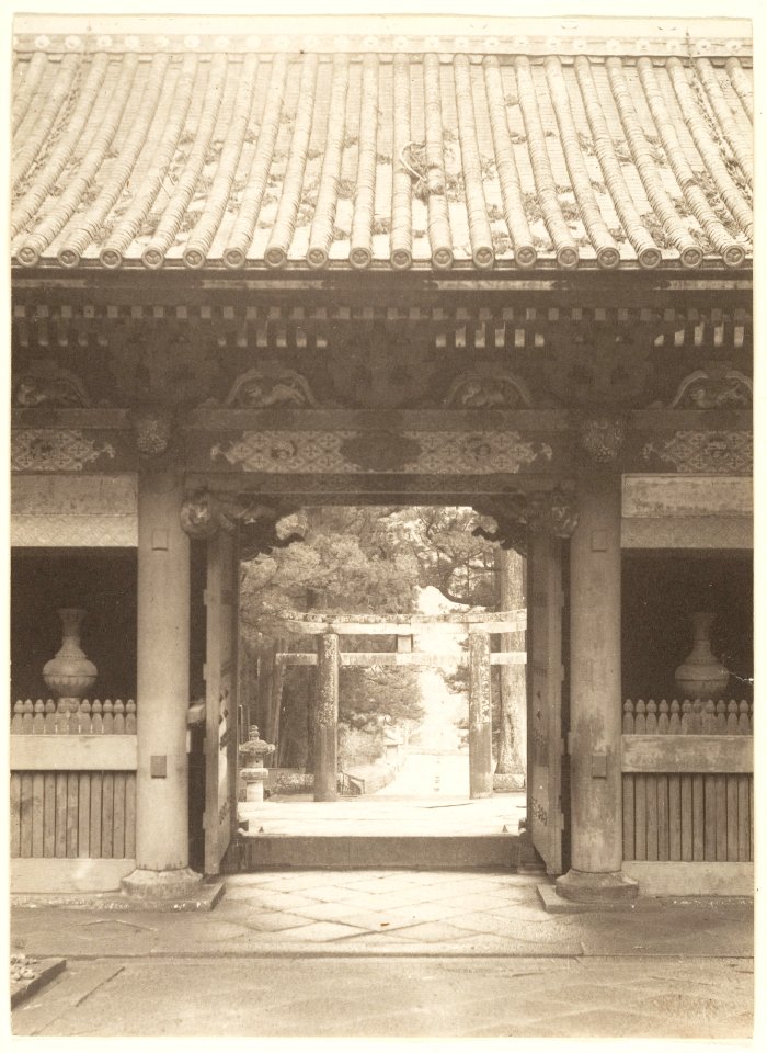View through a gateway into a garden by Adolf de Meyer
