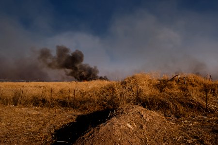 Views of the site of a massacre by the Islamic State and mass grave of Ezidis in Shingal (Sinjar) in summer of 2019 as field fires approach the location 10