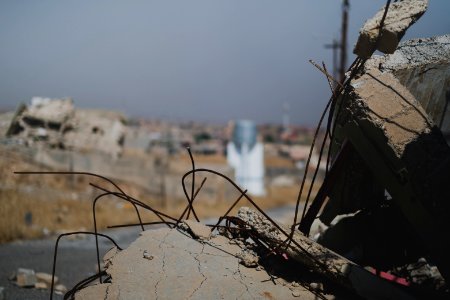 Views on 28th June 2019 around the destroyed city center of Shingal while a field fire rages south of the city 01