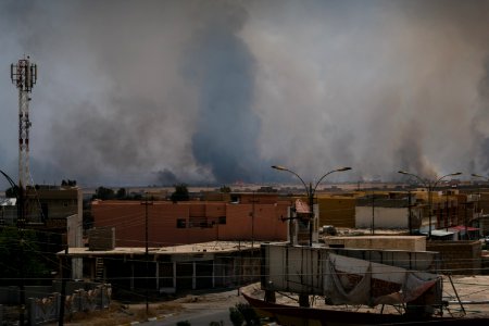 Views on 28th June 2019 around the destroyed city center of Shingal while a field fire rages south of the city 16