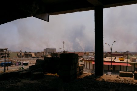 Views on 28th June 2019 around the destroyed city center of Shingal while a field fire rages south of the city 09